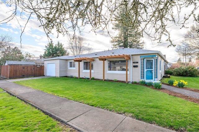 view of front of house featuring an attached garage, an outdoor structure, a front lawn, and fence