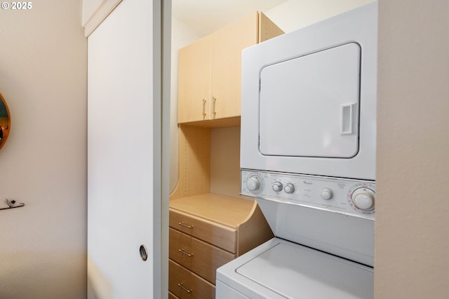 washroom featuring stacked washer and dryer