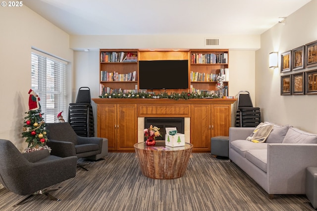 living room with dark colored carpet