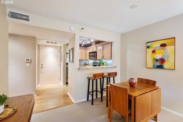 dining room with light colored carpet