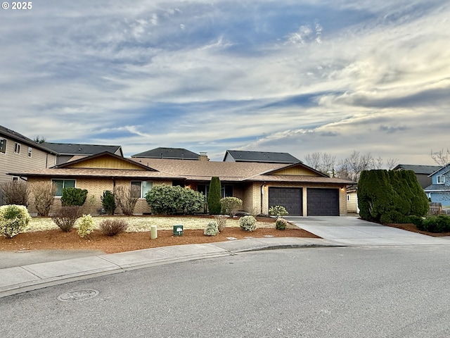 view of front of property featuring roof mounted solar panels, brick siding, concrete driveway, and an attached garage