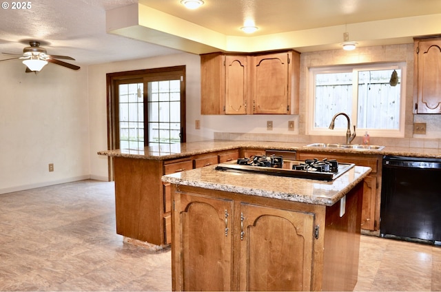 kitchen featuring a ceiling fan, a sink, gas stovetop, a peninsula, and dishwasher