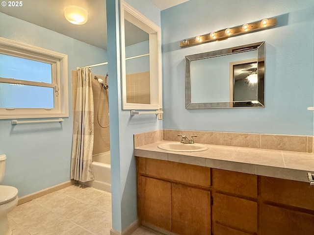 full bathroom featuring shower / bathtub combination with curtain, toilet, tile patterned flooring, baseboards, and vanity