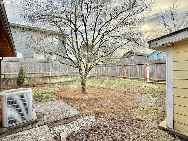 view of yard featuring a fenced backyard and central AC