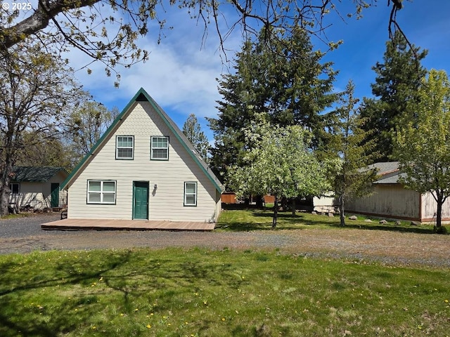 view of front of property with a deck and a front yard
