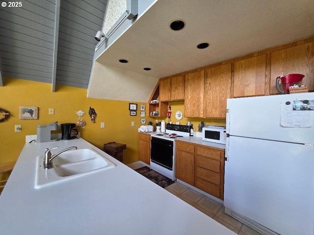 kitchen featuring open shelves, a sink, white appliances, light countertops, and brown cabinetry