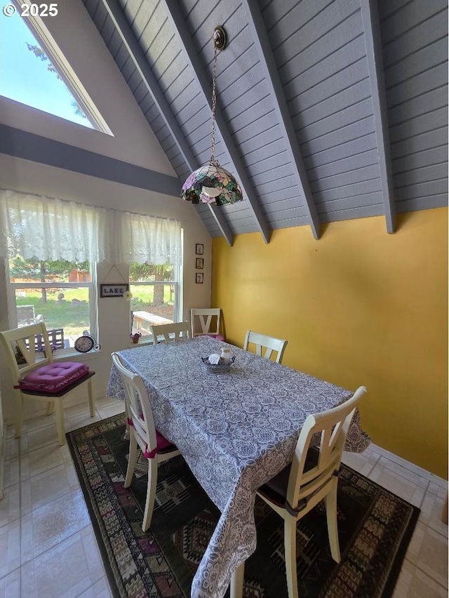 dining space featuring high vaulted ceiling and beamed ceiling