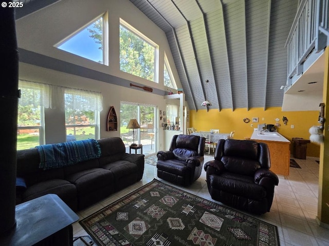 tiled living area with high vaulted ceiling