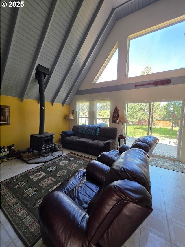 living area featuring beamed ceiling, high vaulted ceiling, and a wood stove