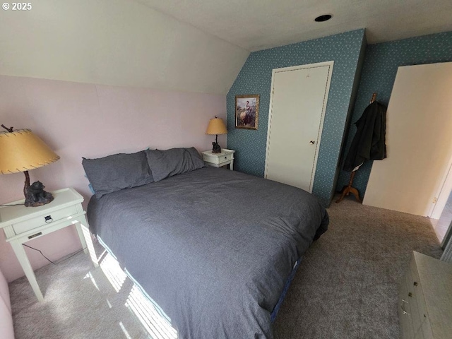 bedroom featuring carpet flooring, wallpapered walls, and lofted ceiling