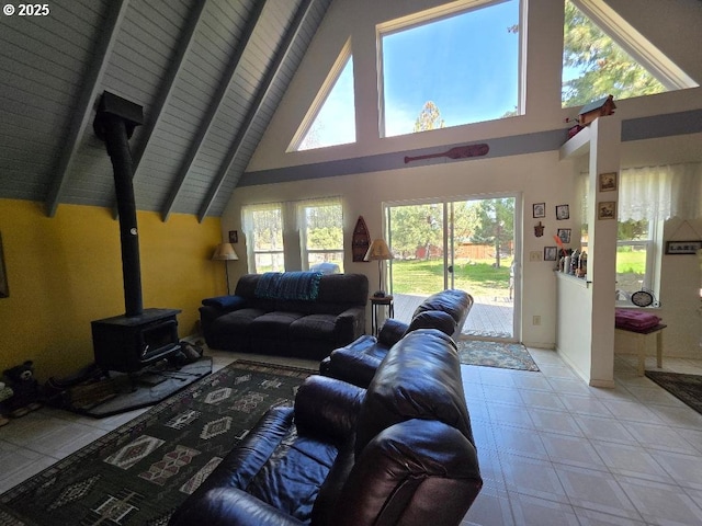 living room featuring beamed ceiling, high vaulted ceiling, and a wood stove