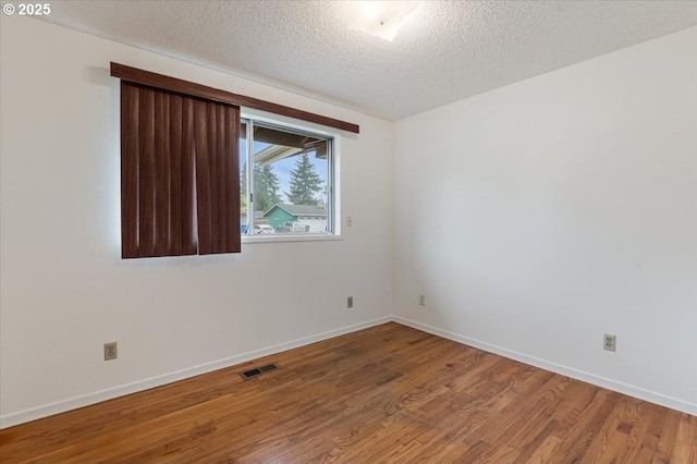 10700 NE 46th St, Vancouver, WA 98682 - empty room featuring wood finished floors, a textured ceiling, and baseboards