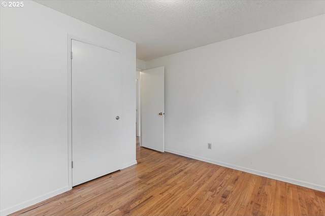 10700 NE 46th St, Vancouver, WA 98682 - unfurnished bedroom featuring light wood-type flooring, baseboards, and a textured ceiling
