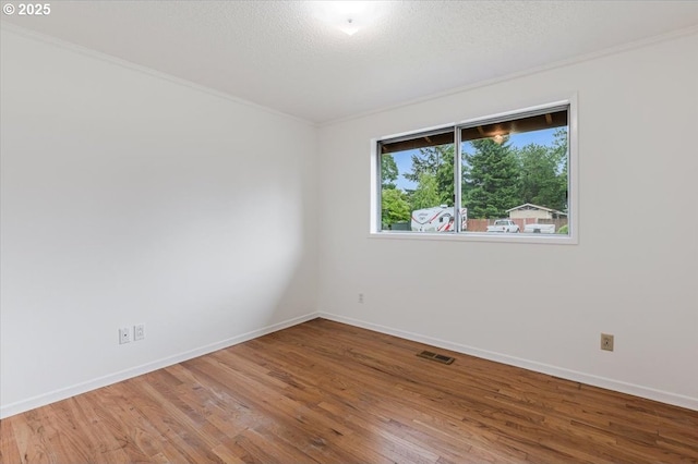 10700 NE 46th St, Vancouver, WA 98682 - spare room featuring wood finished floors, crown molding, baseboards, and a textured ceiling