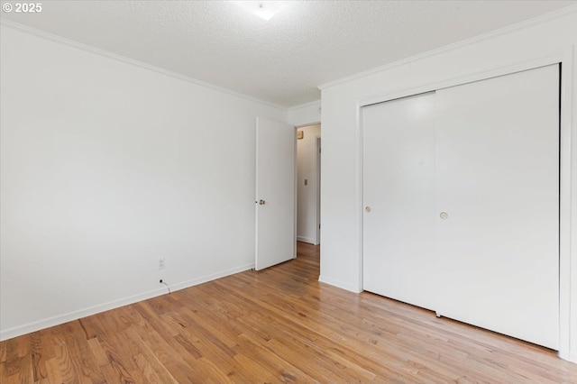 10700 NE 46th St, Vancouver, WA 98682 - unfurnished bedroom with ornamental molding, light wood finished floors, a closet, a textured ceiling, and baseboards