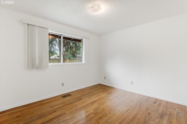 10700 NE 46th St, Vancouver, WA 98682 - spare room with wood finished floors, a textured ceiling, and baseboards