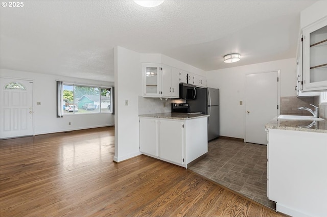 10700 NE 46th St, Vancouver, WA 98682 - kitchen featuring a sink, decorative backsplash, white cabinetry, glass insert cabinets, and a textured ceiling