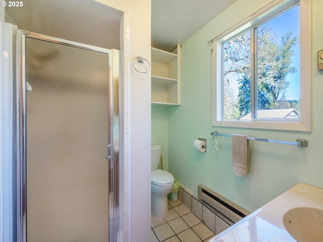 bathroom featuring a sink, tile patterned flooring, a shower stall, and a baseboard radiator
