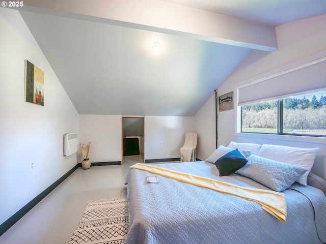 bedroom with lofted ceiling, radiator heating unit, finished concrete floors, and baseboards