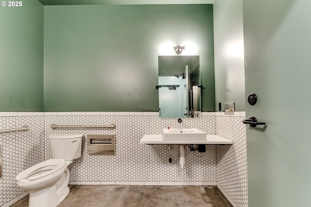 bathroom featuring concrete flooring, sink, and toilet