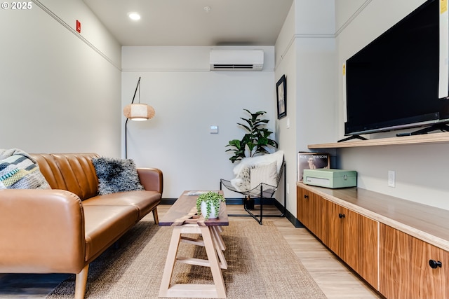 living room with a wall mounted AC and light hardwood / wood-style floors