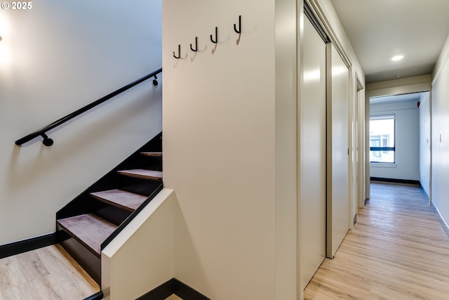 stairs featuring hardwood / wood-style floors