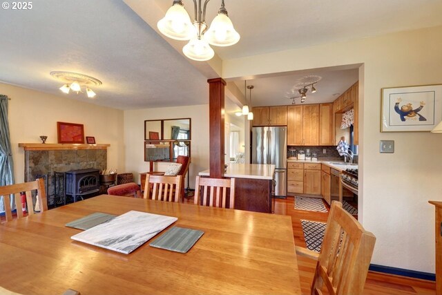 dining space featuring light wood-style floors and a notable chandelier