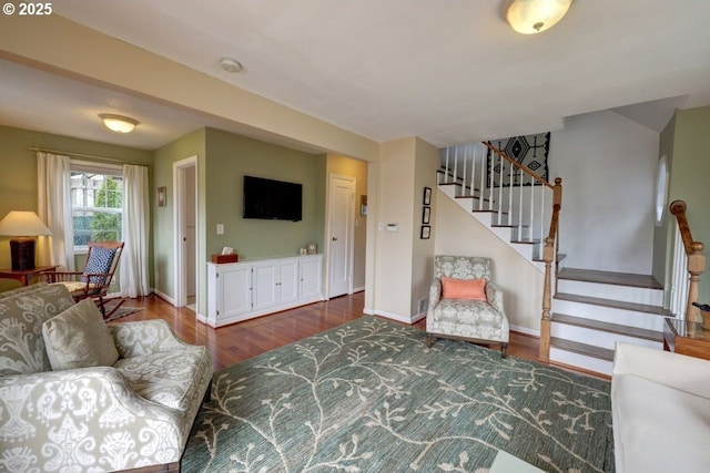 living room with stairway, baseboards, and wood finished floors