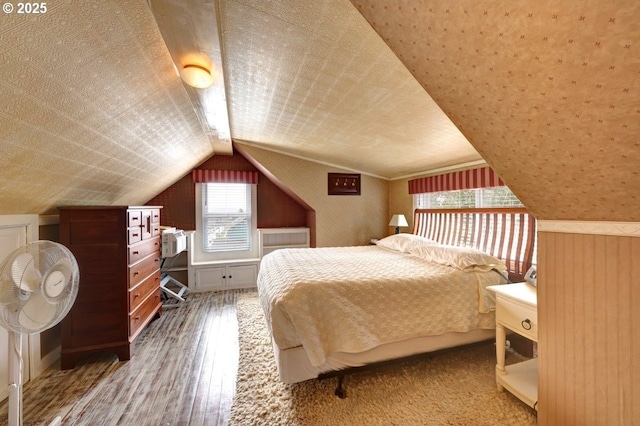 bedroom featuring vaulted ceiling and hardwood / wood-style floors