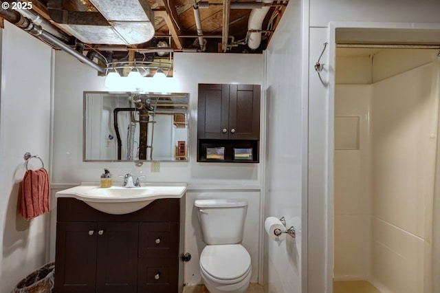 full bath with a stall shower, vanity, and toilet