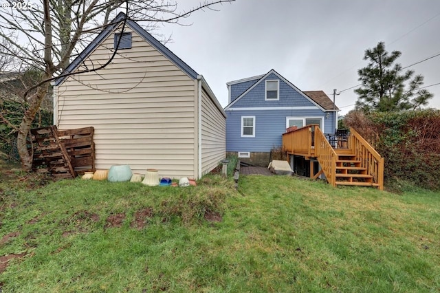 rear view of property with stairs, a lawn, and a wooden deck