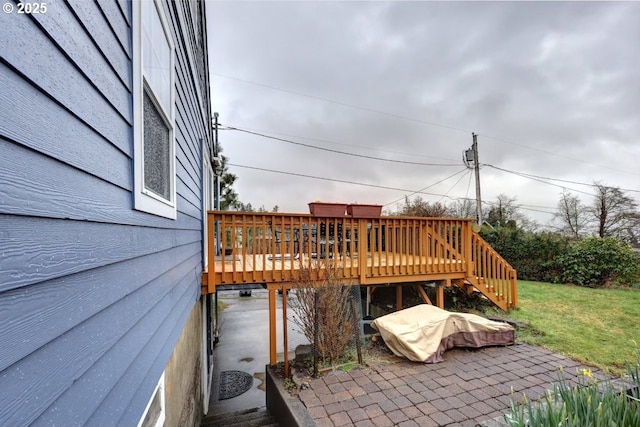 view of patio featuring a deck and stairway