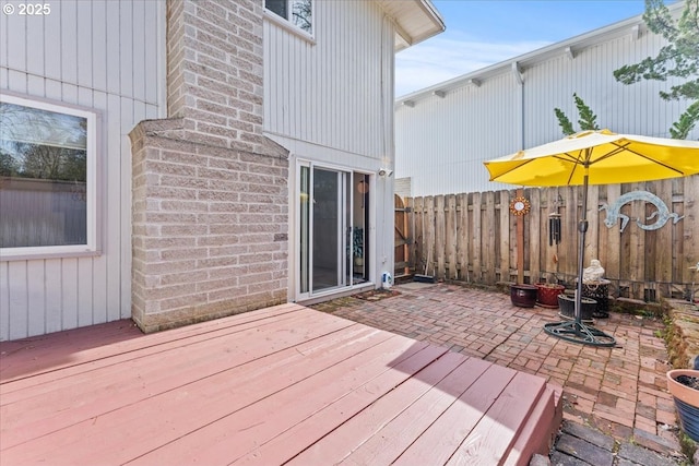 deck featuring a patio and fence