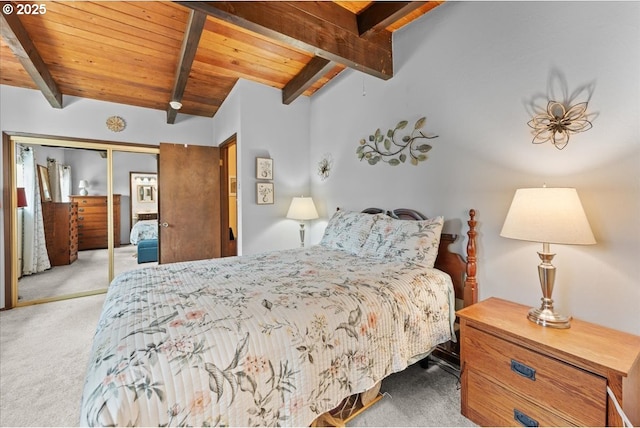 carpeted bedroom with lofted ceiling with beams, wood ceiling, and a closet