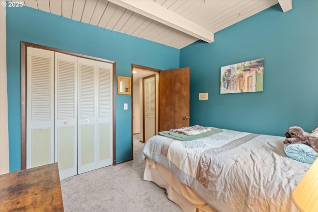 bedroom with a closet, carpet, wooden ceiling, and vaulted ceiling with beams