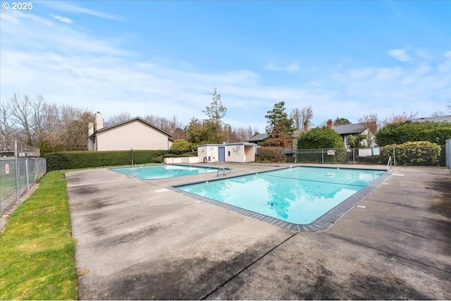 community pool with a patio and fence