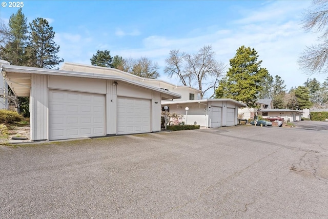 exterior space with aphalt driveway and a garage