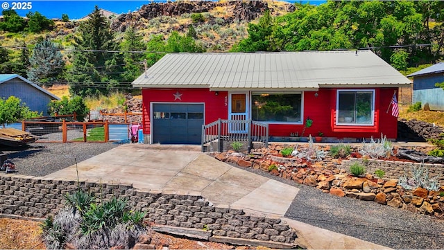 475 Burnham Ave, Maupin, OR 97037 - ranch-style house with concrete driveway, metal roof, and a garage