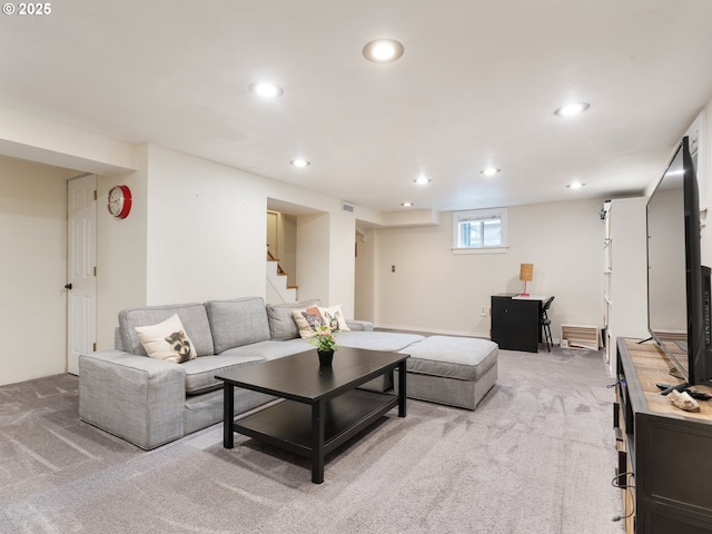 living room featuring recessed lighting, light carpet, and stairway