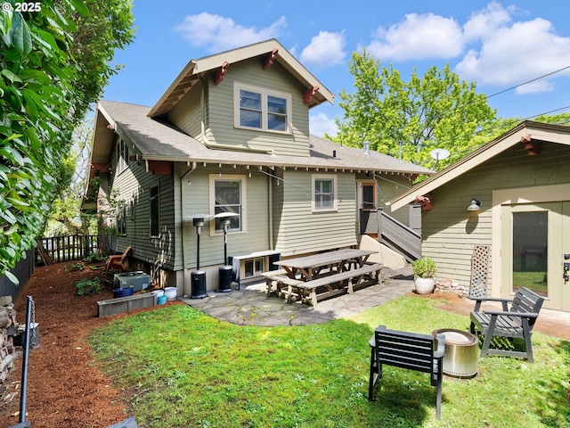 back of property featuring a patio area and roof with shingles