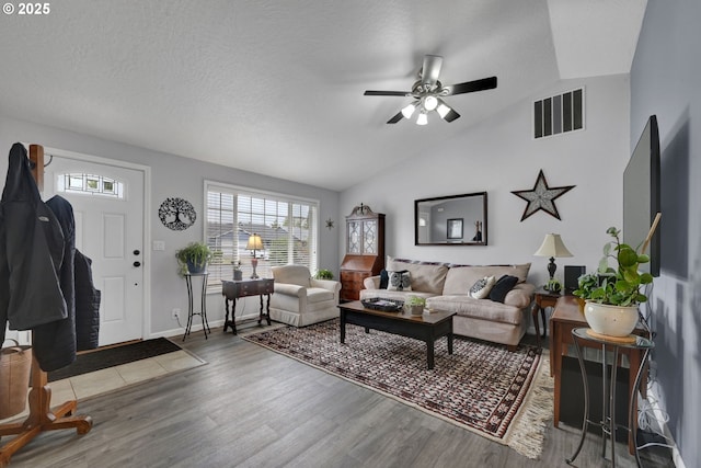 living room featuring ceiling fan, wood finished floors, lofted ceiling, and baseboards