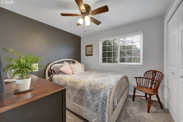 bedroom featuring a closet, carpet, baseboards, and ceiling fan