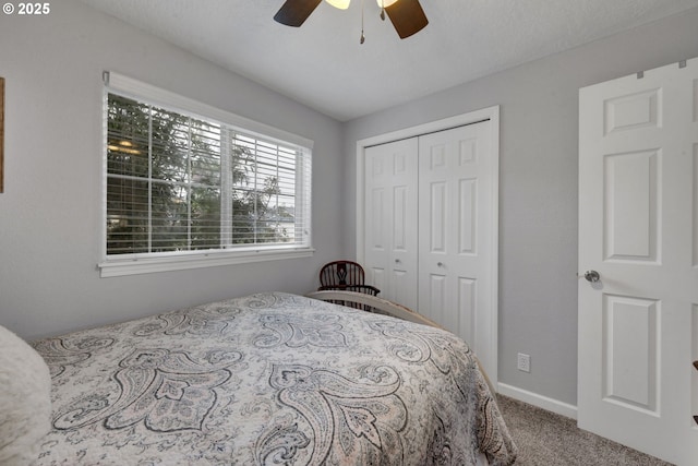 bedroom with carpet flooring, a closet, baseboards, and ceiling fan