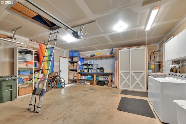 garage with washing machine and dryer, a garage door opener, and water heater