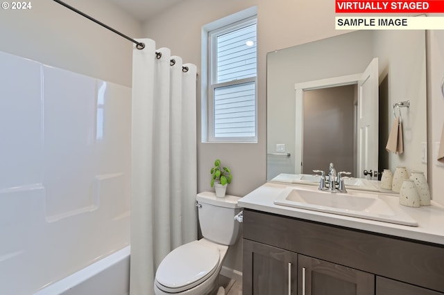 bathroom with shower / bath combo with shower curtain, toilet, and vanity