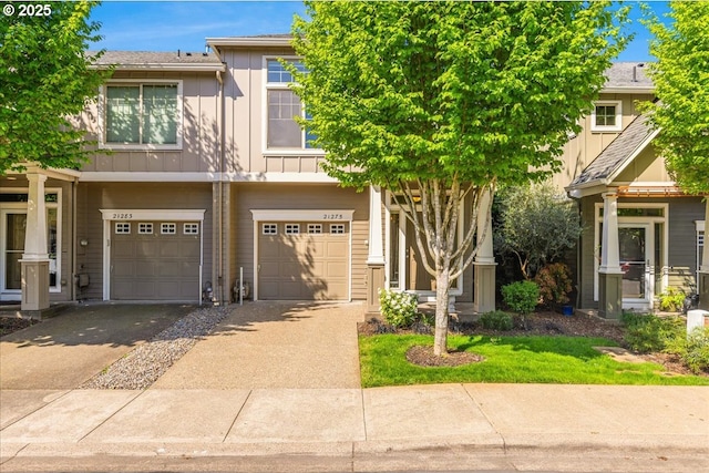 view of property featuring driveway, board and batten siding, and a garage