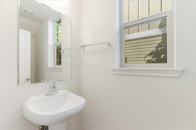 bathroom with visible vents and a sink
