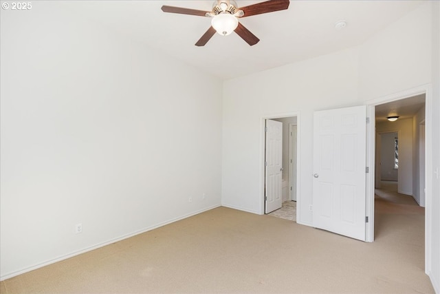 unfurnished bedroom with ceiling fan, baseboards, and light colored carpet
