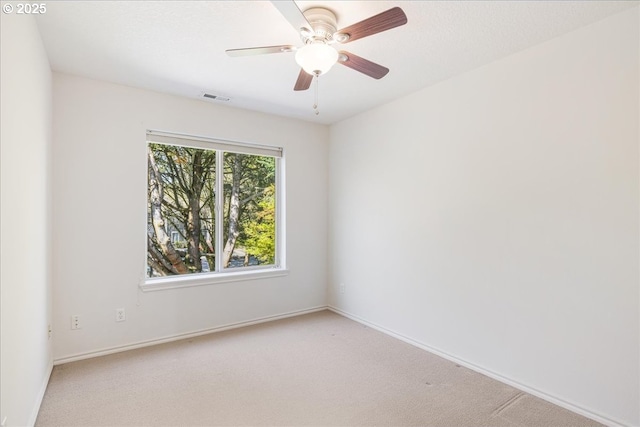 unfurnished room with baseboards, a ceiling fan, visible vents, and carpet flooring