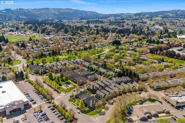 drone / aerial view featuring a residential view and a mountain view